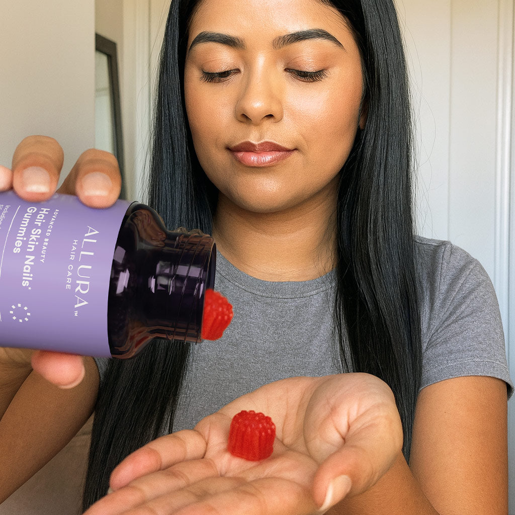 Woman holding bottle with gummies in her hand